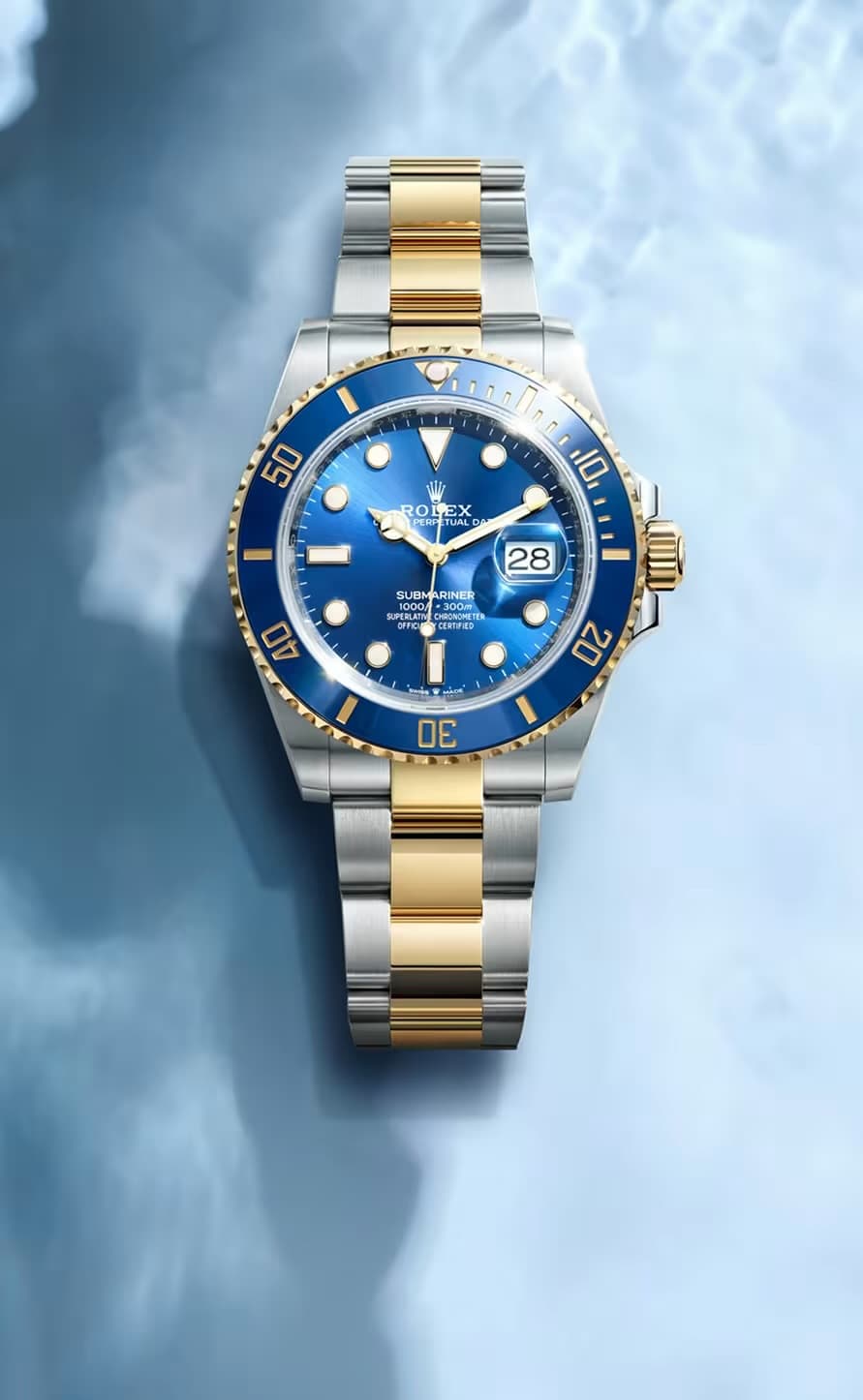 Two-tone gold and steel Rolex Submariner with a blue dial and bezel.