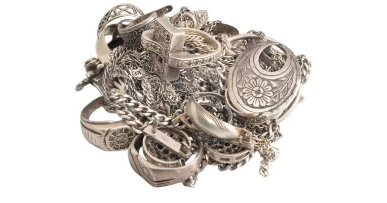 Pile of sterling silver rings, chains and a locket ready to sell.
