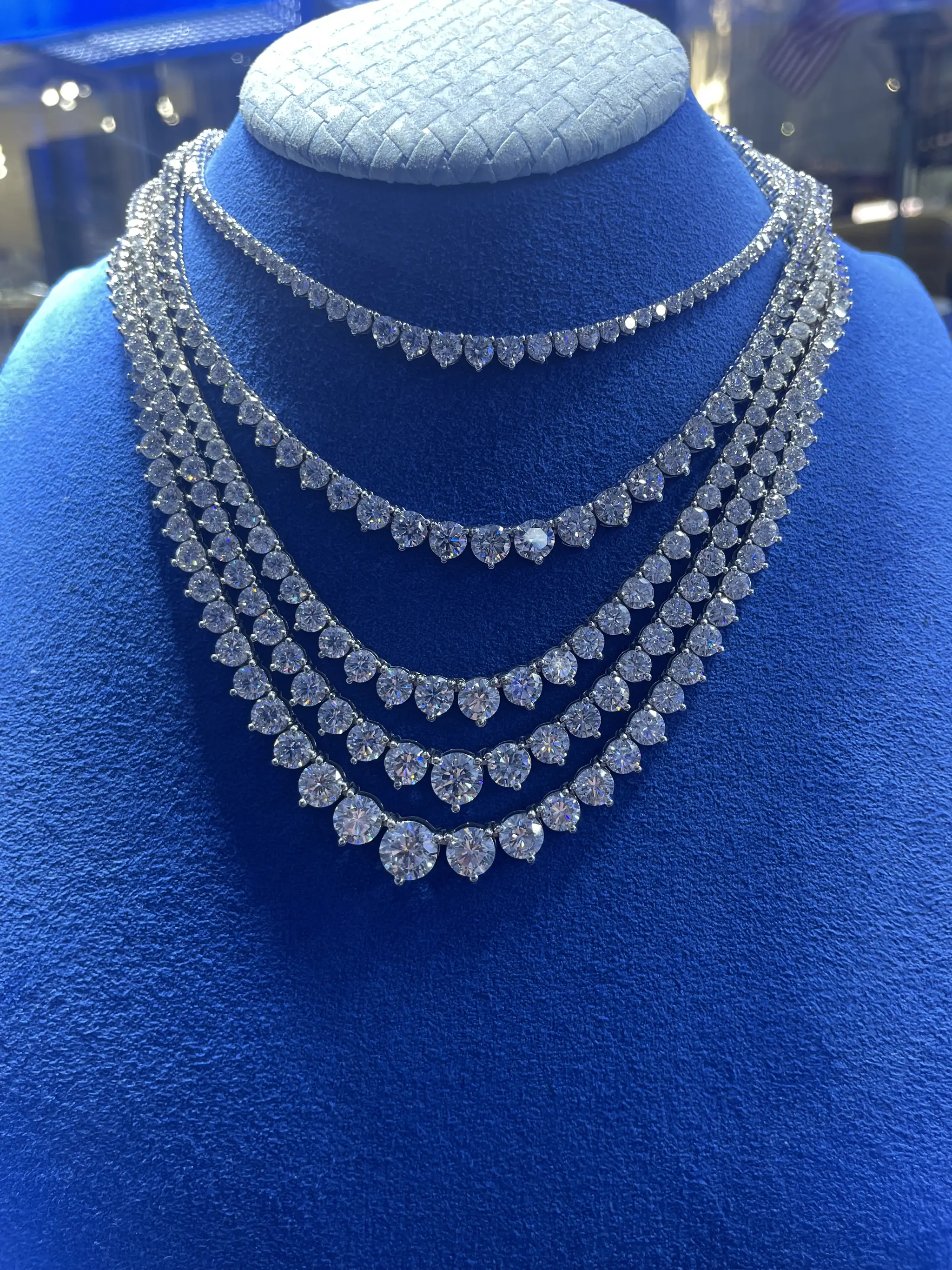 Graduated diamond necklaces on a display bust at Roma Jewelry.