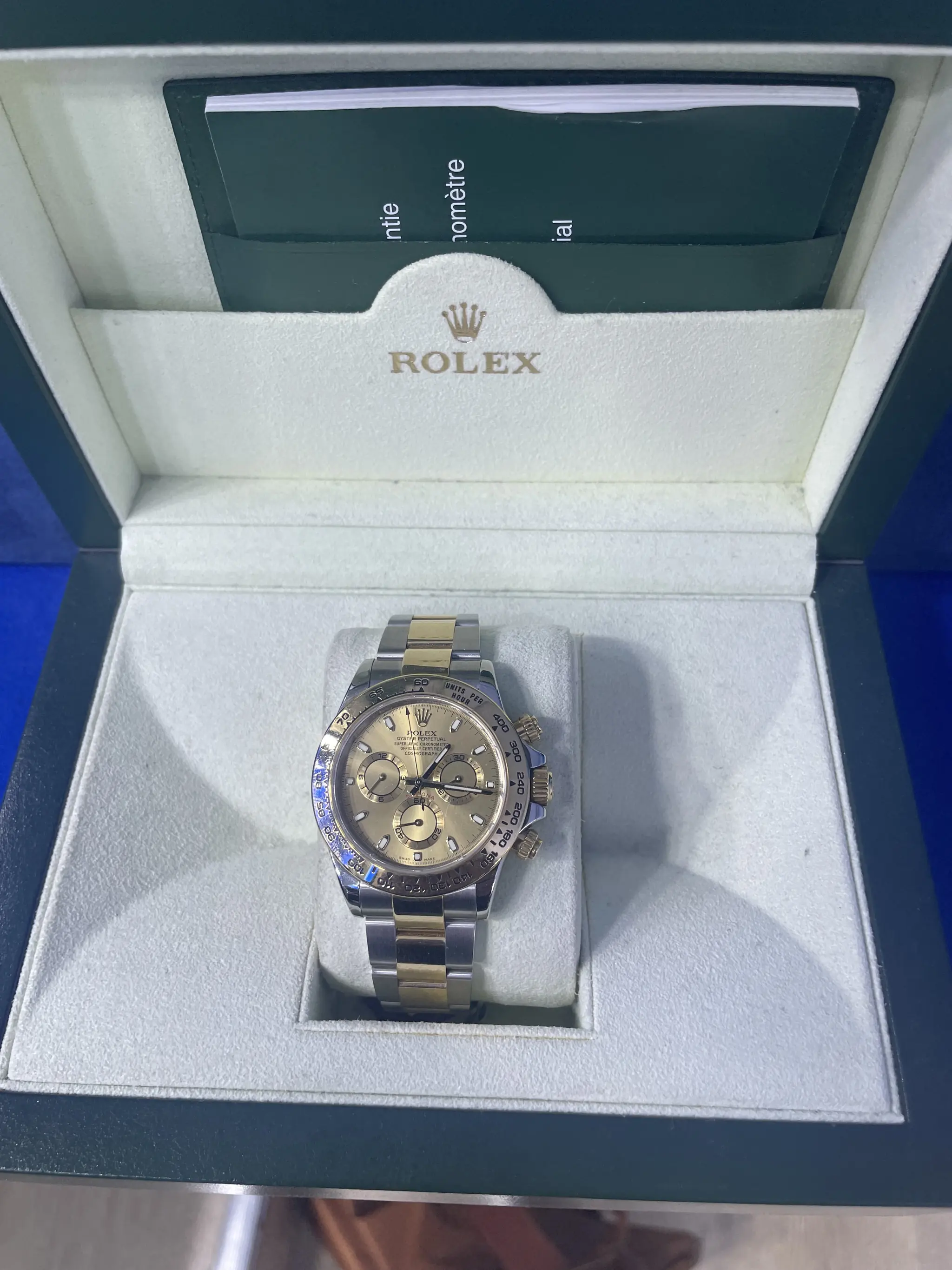 Two-tone Rolex Daytona in its box at Roma Jewelry.