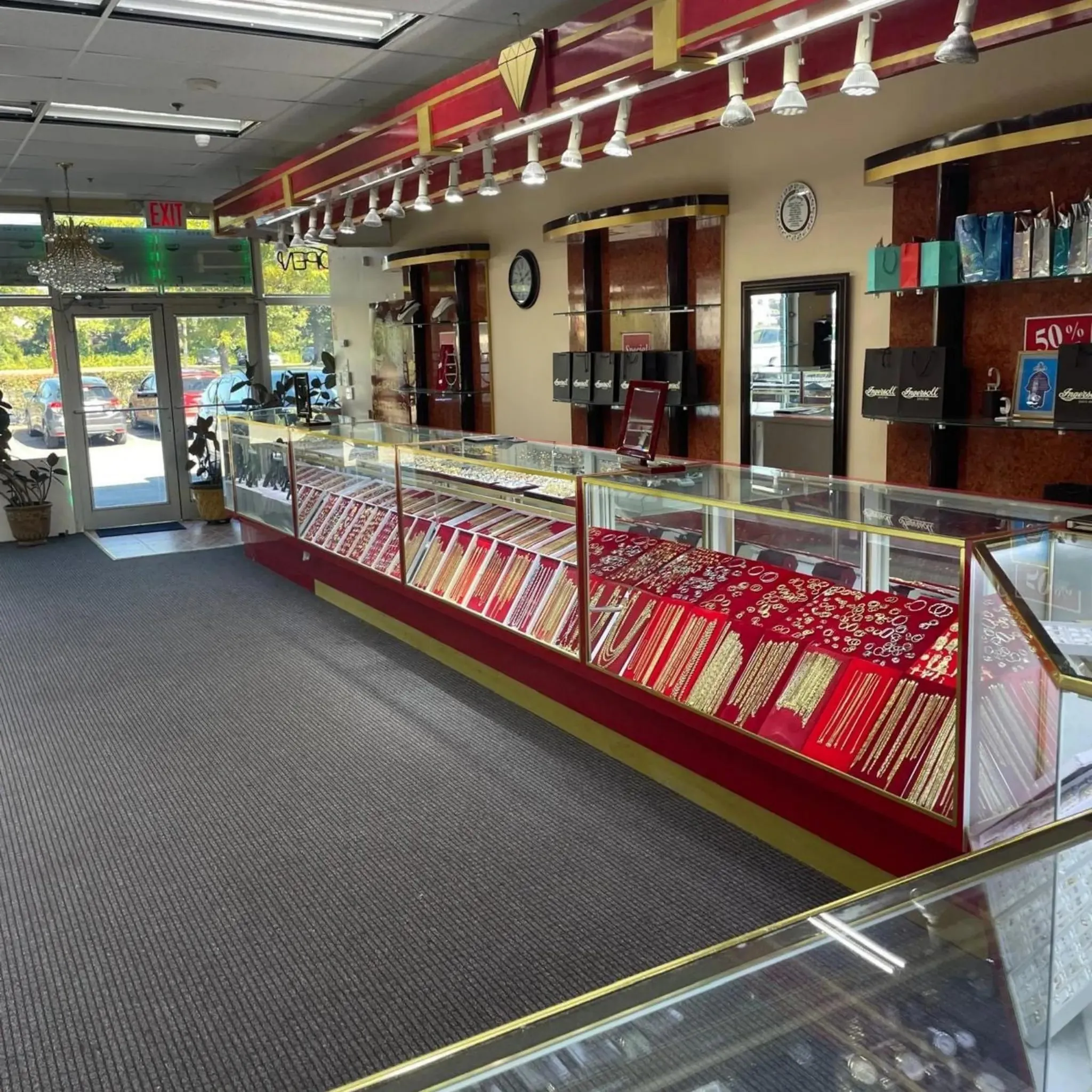 Inside Roma Jewelry on Sunrise Highway in Massapequa: glass display cases of gold chains, rings and diamond jewelry.