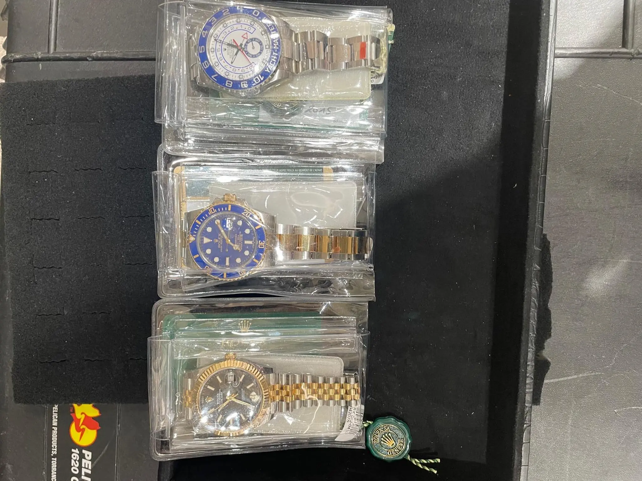 Tray of pre-owned luxury watches, including Rolex, at Roma Jewelry in Massapequa.